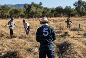 Volunteers work during a project to renovate a burial ground for refugees and migrants in a state of disarray, in the village of Kato Tritos, on the island of Lesbos, Greece, October 12, 2023.
