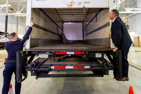 Police officers open the back of the truck used in the heist after authorities gave details of the arrests made one year after some 400 kg (882 pounds) of gold and almost $2 million USD in cash was stolen from Toronto Pearson International Airport, at a news conference in Brampton, Ontario, Canada April 17, 2024. 