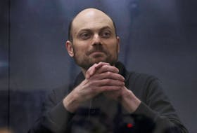 Jailed Russian opposition figure Vladimir Kara-Murza gestures as he stands behind a glass wall of an enclosure for defendants during a court hearing to consider an appeal against his prison sentence, in Moscow, Russia July 31, 2023.