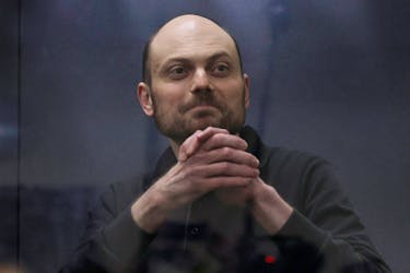 Jailed Russian opposition figure Vladimir Kara-Murza gestures as he stands behind a glass wall of an enclosure for defendants during a court hearing to consider an appeal against his prison sentence, in Moscow, Russia July 31, 2023.