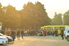 Residents gather next to buses in central Stepanakert before leaving Nagorno-Karabakh, a region inhabited by ethnic Armenians, September 25, 2023.