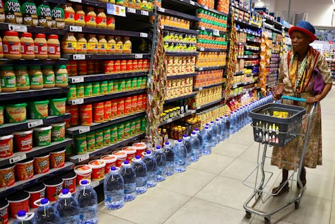 A woman uses a trolley as she shops at a Pick n Pay store at the Dobson Point Shopping Centre, in Soweto, South Africa, March 19, 2024.