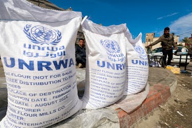 Displaced Palestinians wait to receive United Nations Relief and Works Agency (UNRWA) aid, amid the ongoing conflict between Israel and the Palestinian Islamist group Hamas, in Rafah, in the southern Gaza Strip, March 7, 2024.