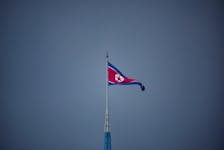A North Korean flag flutters at the propaganda village of Gijungdong in North Korea, in this picture taken near the truce village of Panmunjom inside the demilitarized zone (DMZ) separating the two Koreas, South Korea, July 19, 2022. 