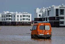 A view shows a minibus on a flooded street in Orenburg, Russia, April 12, 2024.