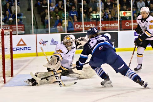 Cape Breton Eagles goaltender Nicolas Ruccia, left, makes a right pad save on Samuel Vachon of the Chicoutimi Saguenéens during Game 4 of the Quebec Maritimes Junior Hockey League second-round playoff series at Centre Georges-Vézina in Chicoutimi, Que., on Wednesday. Cape Breton won the game 8-5 and wins the series 4-0. CONTRIBUTED/BRUNO GIRARD