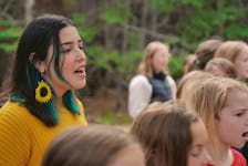 Emma Stevens, who saw popular reaction to her Mi'kmaw language cover of the song 'Blackbird' by The Beatles in 2019, sings the chorus of 'We are the Love," alongside students from both Riverside and Marion Bridge Elementary School choirs.  CONTRIBUTED/EYM Project