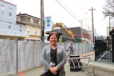 Sabrina Vatcher, the chief executive officer of YMCA Cape Breton, stands by a construction fence outside of the Frank Rudderham Family YMCA on Charlotte Street. The YMCA is one of several downtown businesses that will have to contend with the interruptions coming from the street's redevelopment work this year, but Vatcher says the YMCA and Cape Breton Regional Municipality have arrangements in place to keep things running as smoothly as possible for at least the next four months. LUKE DYMENT/CAPE BRETON POST