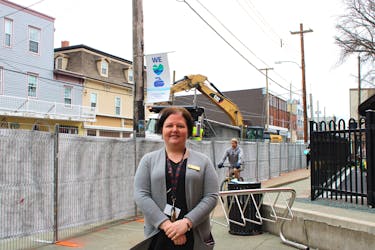 Sabrina Vatcher, the chief executive officer of YMCA Cape Breton, stands by a construction fence outside of the Frank Rudderham Family YMCA on Charlotte Street. The YMCA is one of several downtown businesses that will have to contend with the interruptions coming from the street's redevelopment work this year, but Vatcher says the YMCA and Cape Breton Regional Municipality have arrangements in place to keep things running as smoothly as possible for at least the next four months. LUKE DYMENT/CAPE BRETON POST