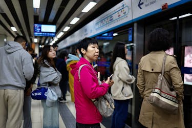 People wait for a subway train during morning rush hour in Beijing, China April 11, 2024.