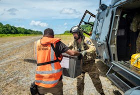 Members of the New Zealand Defence Force (NZDF) Joint Task Force assist in delivering ballot boxes by NH90 helicopter to remote areas of the Solomon Islands ahead of the upcoming election, Solomon Islands, in this handout image released on April 17, 2024. New Zealand Defence Force/Handout via