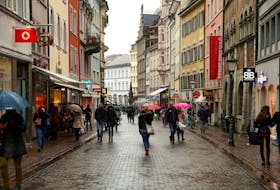 People walk on a shopping street in the southern German town of Konstanz January 17, 2015.