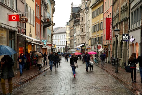 People walk on a shopping street in the southern German town of Konstanz January 17, 2015.