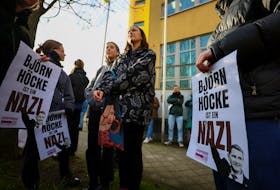 Demonstrators, holding placards that read "Bjoern Hoecke is a Nazi", protest against German far-right politician of the Alternative for Germany (AfD) Bjoern Hoecke on the day of his trial over the alleged use of Nazi vocabulary during a speech in May 2021, at the regional court in the major city of Halle, Germany April 18, 2024.