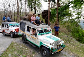 Vehicles carrying election materials move through Buxa Tiger Reserve forest to reach to a remote polling station, ahead of the first phase of India's general election, in Alipurduar district in the eastern state of West Bengal, India, April 18, 2024.