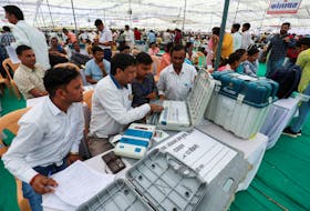 Election staff check the Electronic Voting Machines (EVM) at a polling station, ahead of the first phase of the election, in Bikaner, Rajasthan, India, April 18, 2024.