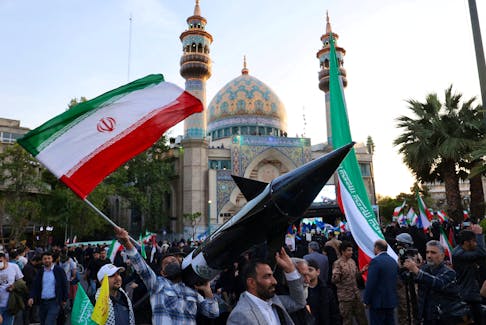 Iranians carry a model of a missile during a celebration following the IRGC attack on Israel, in Tehran, Iran, April 15, 2024. Majid Asgaripour/WANA (West Asia News Agency) via