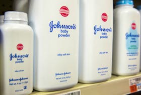 Bottles of Johnson & Johnson baby powder line a drugstore shelf in New York October 15, 2015. 