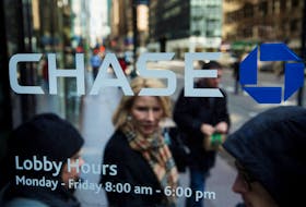 A customer walks out of a branch of the JPMorgan Chase & Co bank in New York, March 15, 2013.