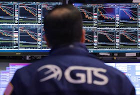 Market information is displayed on monitors as a trader works on the trading floor at the New York Stock Exchange (NYSE) in New York City, U.S., April 4, 2024.