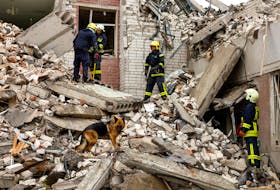 A dog stands on rubble as rescuers work at the site of a destroyed building during a Russian missile strike, amid Russia's attacks on Ukraine, in Chernihiv, Ukraine April 17, 2024.