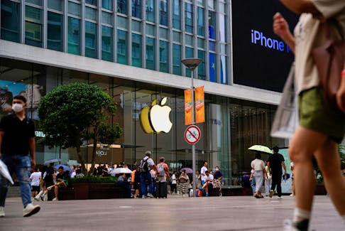 People walk past an Apple store in Shanghai, China September 13, 2023.