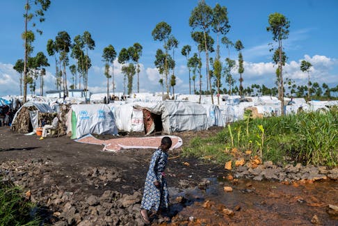 A displaced Congolese child walks at a new site, after fleeing their village following clashes between M23 rebels and the Armed Forces of the Democratic Republic of the Congo (FARDC), in Sake, the Democratic Republic of Congo February 6, 2024.