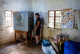 Polling officer Stevenson M. Khonglah, sets up the polling booth in Nongriat village, the location of a remote polling station, on the eve of the first phase of the election, in Shillong in the northeastern state of Meghalaya, India, April 18, 2024.