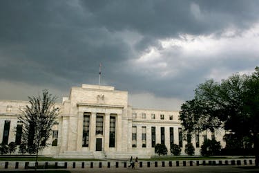 Storm clouds gather over the U.S. Federal Reserve Building before an evening thunderstorm in Washington June 9, 2006.
