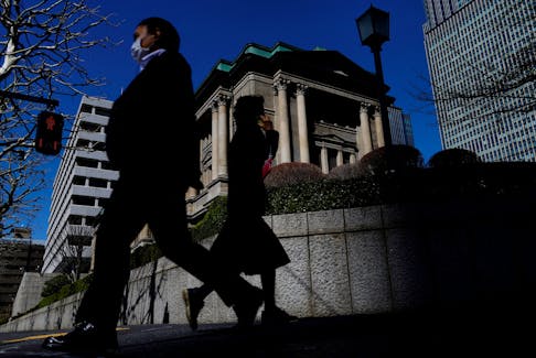 Pedestrians walk past the Bank of Japan building in Tokyo, Japan March 18, 2024.