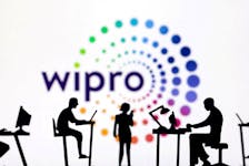 Figurines with computers and smartphones are seen in front of Wipro logo in this illustration taken, February 19, 2024.