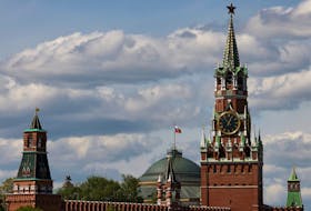 The Russian flag flies on the dome of the Kremlin Senate building behind Spasskaya Tower, in central Moscow, Russia, May 4, 2023.