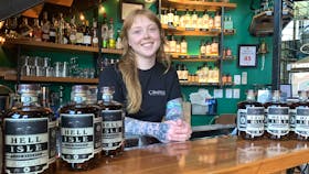 Miranda Parker, head distiller at Compass Distillers, with bottles of Hell Isle rum, something of a departure for the company and which is already selling well. - BILL SPURR / THE CHRONICLE HERALD