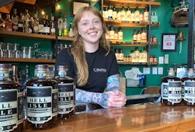 Miranda Parker, head distiller at Compass Distillers, with bottles of Hell Isle rum, something of a departure for the company and which is already selling well. - BILL SPURR / THE CHRONICLE HERALD