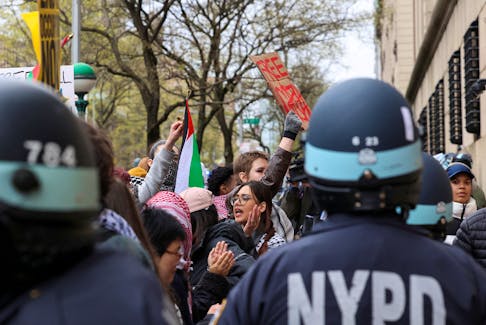 Law enforcement officers stand guard as demonstrators protest in solidarity with Pro-Palestinian organizers on the Columbia University campus, amid the ongoing conflict between Israel and the Palestinian Islamist group Hamas, in New York City, U.S., April 18, 2024.