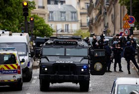 French police and members of French special police forces of Research and Intervention Brigade (BRI) secure the area near Iran consulate where a man is threatening to blow himself up, in Paris, France, April 19, 2024.