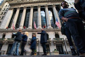 People walk outside the New York Stock Exchange in New York, U.S., December 29, 2023.