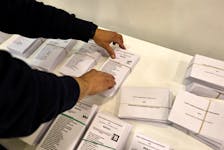 A worker prepares a polling station ahead of Sunday's elections in Spain's autonomous Basque Country, where left-wing separatists of EH Bildu party seek to dislodge the conservative Basque Nationalist Party, in power almost continuously since the 1980's, in Bilbao, Spain, April 19, 2024.