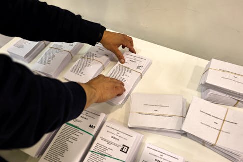 A worker prepares a polling station ahead of Sunday's elections in Spain's autonomous Basque Country, where left-wing separatists of EH Bildu party seek to dislodge the conservative Basque Nationalist Party, in power almost continuously since the 1980's, in Bilbao, Spain, April 19, 2024.