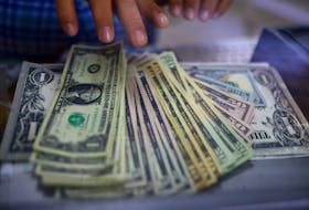 The employee of a currency exchange shop counts U.S. dollar banknotes in Ciudad Juarez, Mexico July 27, 2023.