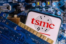 A smartphone with a displayed TSMC (Taiwan Semiconductor Manufacturing Company) logo is placed on a computer motherboard in this illustration taken March 6, 2023.