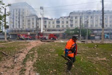 A municipal worker removes debris at a site of an apartment building hit by a Russian missile strike, amid Russia's attack on Ukraine, in Dnipro, Ukraine April 19, 2024.