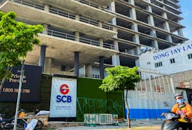 A logo of Saigon Joint Stock Commercial Bank (SCB) is seen in front of an under-construction building in Ho Chi Minh City, Vietnam, November 30, 2023.