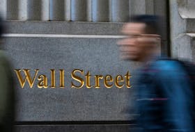 People walk around the New York Stock Exchange in New York, U.S., December 29, 2023.