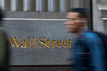 People walk around the New York Stock Exchange in New York, U.S., December 29, 2023.