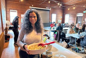 Charlottetown resident Sukriti Chopra displays her homemade chickpea salad, which she brought to a vegan community potluck, organized by Islanders Protecting Animals, a local group of animal advocates. More than 40 people attended the event at Beaconsfield Carriage House in Charlottetown on March 31. Thinh Nguyen • The Guardian