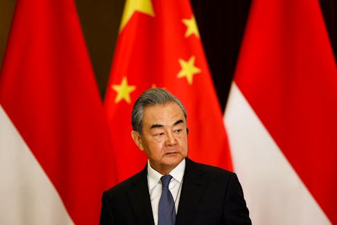 Chinese Foreign Minister Wang Yi listens during a joint press conference with Indonesian Foreign Minister Retno Marsudi (not pictured) following their bilateral meeting in Jakarta, Indonesia, April 18, 2024.