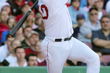 Dave McCarty of the Boston Red Sox watches his game-winning two-run home run, scoring teammate Jason Varitek, to win the game against the Seattle Mariners in the twelfth inning at Boston's Fenway Park, May 30, 2004. 