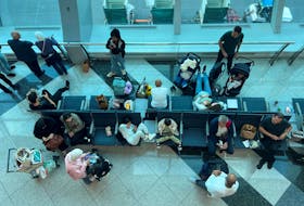 Passengers wait for their flight after a rainstorm hit Dubai, causing delays at the Dubai International Airport, in Dubai, United Arab Emirates, April 17, 2024.