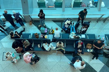 Passengers wait for their flight after a rainstorm hit Dubai, causing delays at the Dubai International Airport, in Dubai, United Arab Emirates, April 17, 2024.